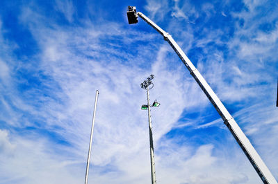 View of cherry lifter and flood lights against sky