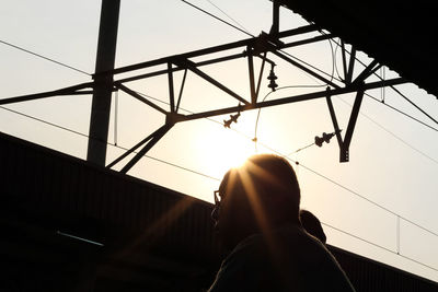 Low angle view of woman standing against sky