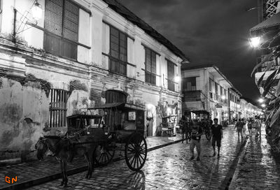 Street amidst buildings in city at night