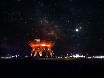 Low angle view of kazan family center against starry sky at night