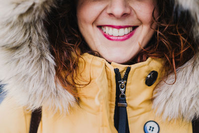 Close-up portrait of a smiling young woman in winter