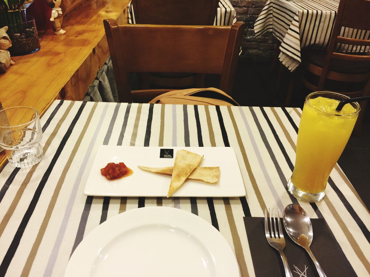 table, indoors, food and drink, chair, drink, still life, freshness, high angle view, restaurant, fork, absence, plate, drinking glass, refreshment, place setting, food, empty, no people, yellow, home interior