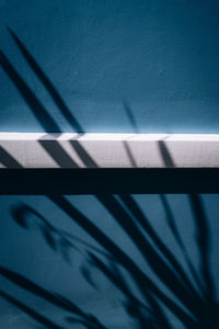 High angle view of shadow on railing