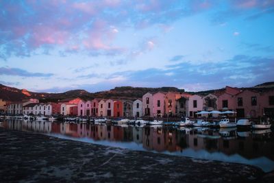 Residential buildings by town against sky
