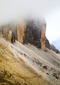 Idyllic view of dolomites against cloudy sky