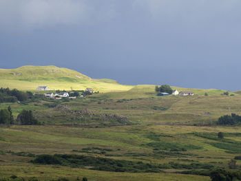 Scenic view of green landscape against sky