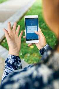 Close-up of woman using smart phone outdoors