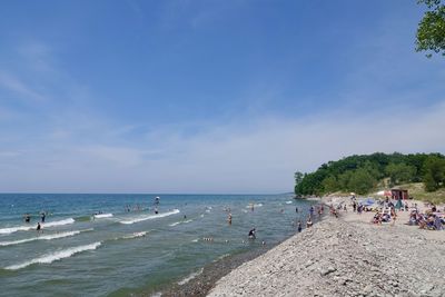 People on beach against sky