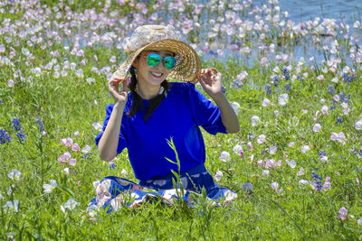 Young woman standing on flowering field