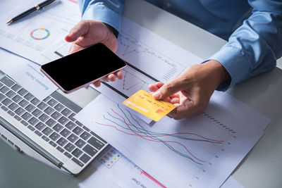 High angle view of man using laptop on table