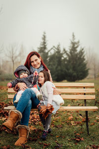 Woman sitting on bench in winter