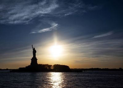 Statue of liberty against sky during sunset