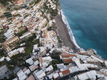 High angle view of townscape by sea