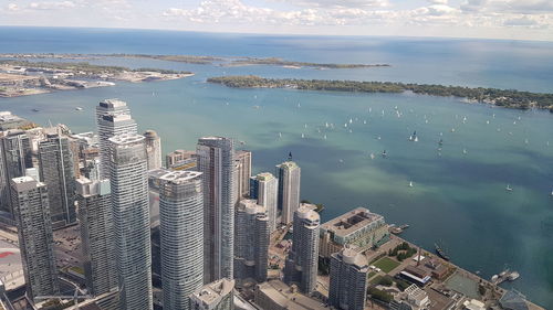 High angle view of buildings by sea against sky