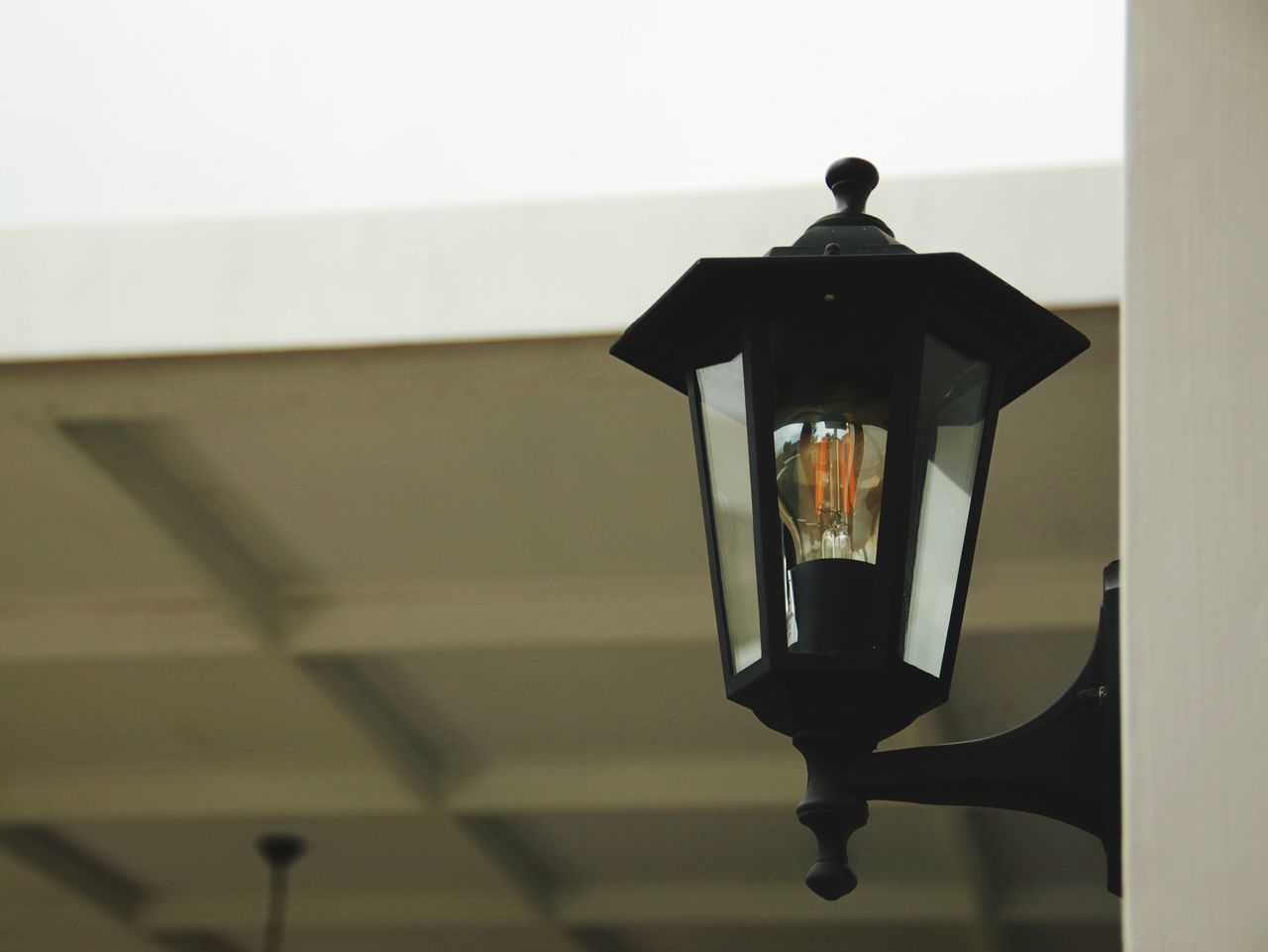 CLOSE-UP OF ILLUMINATED LAMP ON WALL