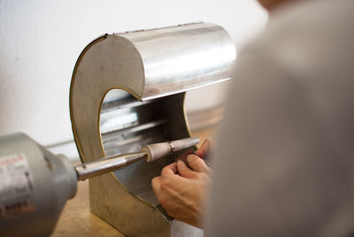 Close-up of goldsmith working on ring