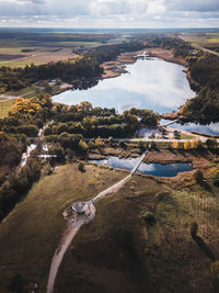 Aerial view of river amidst trees against sky