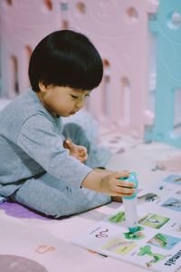 Close-up of boy playing with toy blocks at home