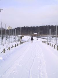 Snow covered field against sky