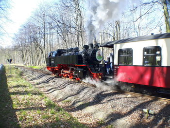 Train on railroad track against sky