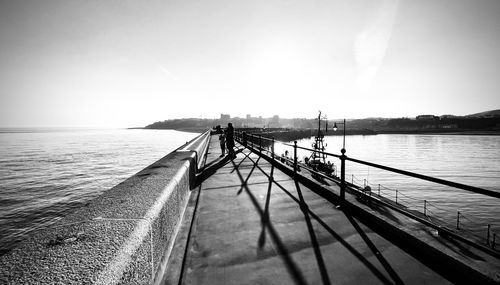 Pier on sea against clear sky