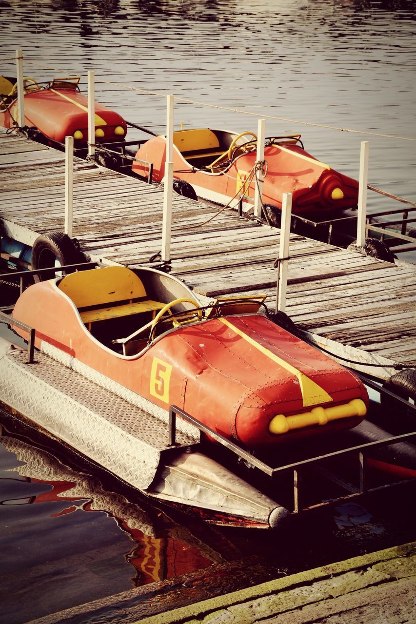 BOATS MOORED BY LAKE