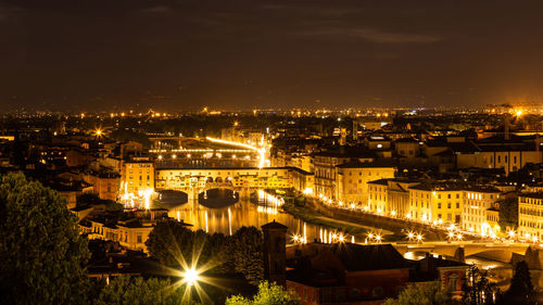 High angle view of illuminated buildings against sky at night