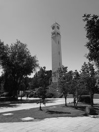 Trees and tower against clear sky