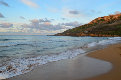 Scenic view of beach at sunset