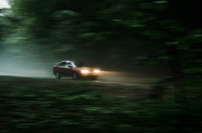 Blurred motion of car on road at night