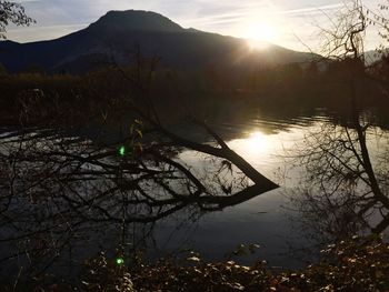 Scenic view of lake against bright sun