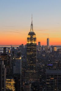 View of buildings in city at sunset