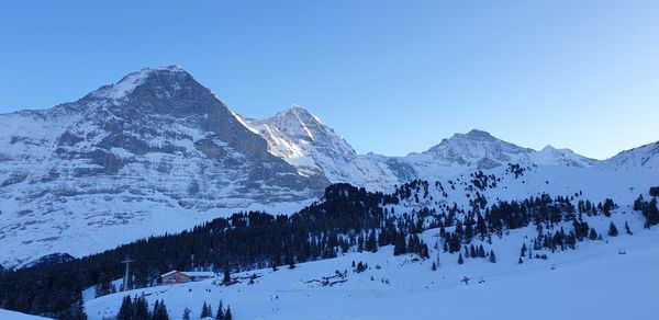 Scenic view of snowcapped mountains against clear sky