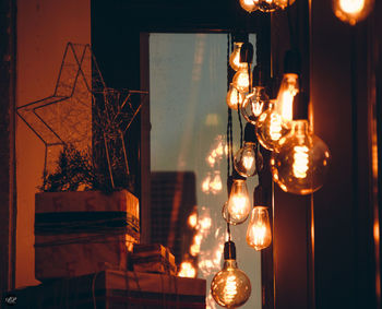 Illuminated light bulbs hanging at home