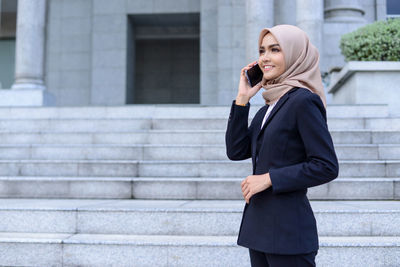 Full length of a young woman using phone