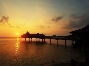 Scenic view of sea against orange sky