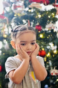 Portrait of cute boy with christmas tree