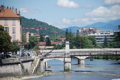 Bridge over river with buildings in background