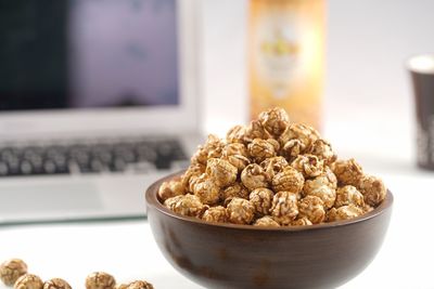 Close-up of caramel corn in bowl on table