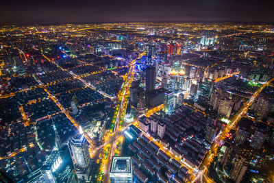 High angle view of city lit up at night