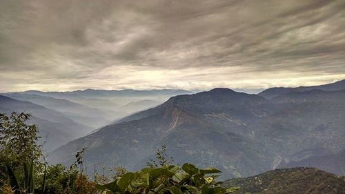 Scenic view of mountains against cloudy sky