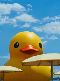 Inflatable duckling against sky