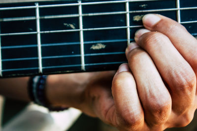 Close-up of hand playing guitar