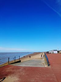 Scenic view of beach against blue sky