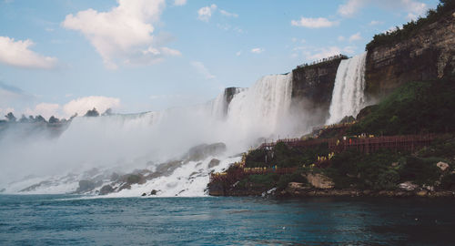 Scenic view of waterfall against sky