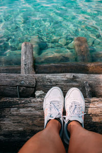 Low section of woman legs on wood