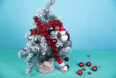 Close-up of christmas decoration on table against blue background