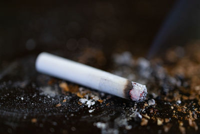 Close-up of cigarette smoking on table
