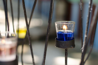 Close-up of lit tea light candle on holder