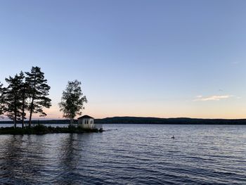 Scenic view of lake against sky at sunset